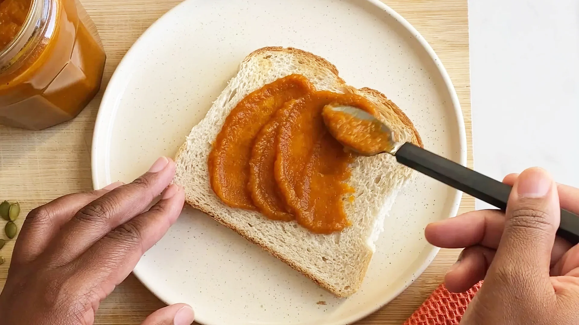 Someone spread the pumpkin butter smoothly over a slice of Hovis Farmhouse batch