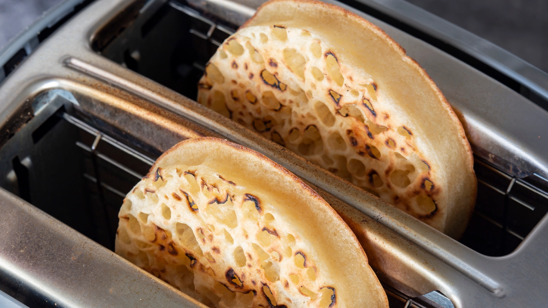 Two toasted Hovis Crumpets coming out of a toaster.