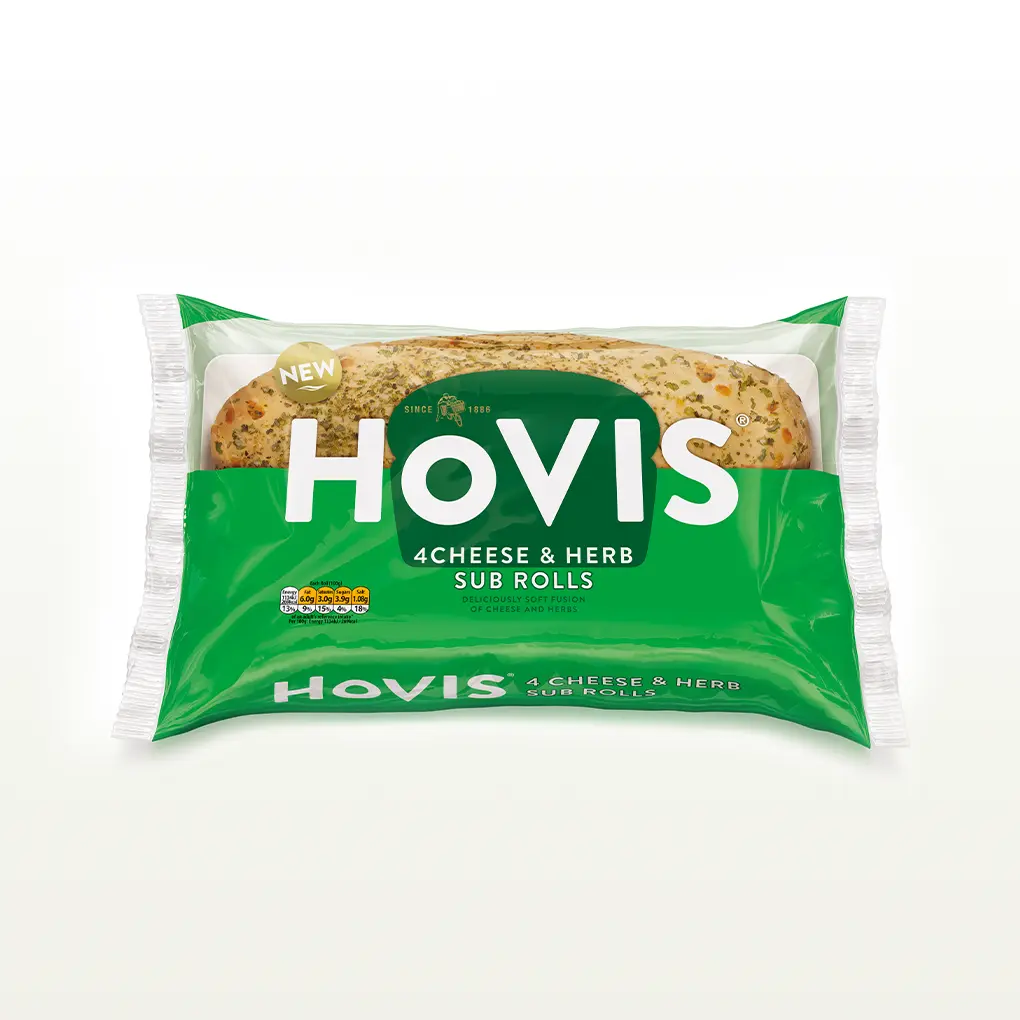 The pack shows two soft sub rolls with herbs and highlights “Deliciously soft fusion of cheese and herbs.” The pack sits on a white backdrop with a subtle shadow.