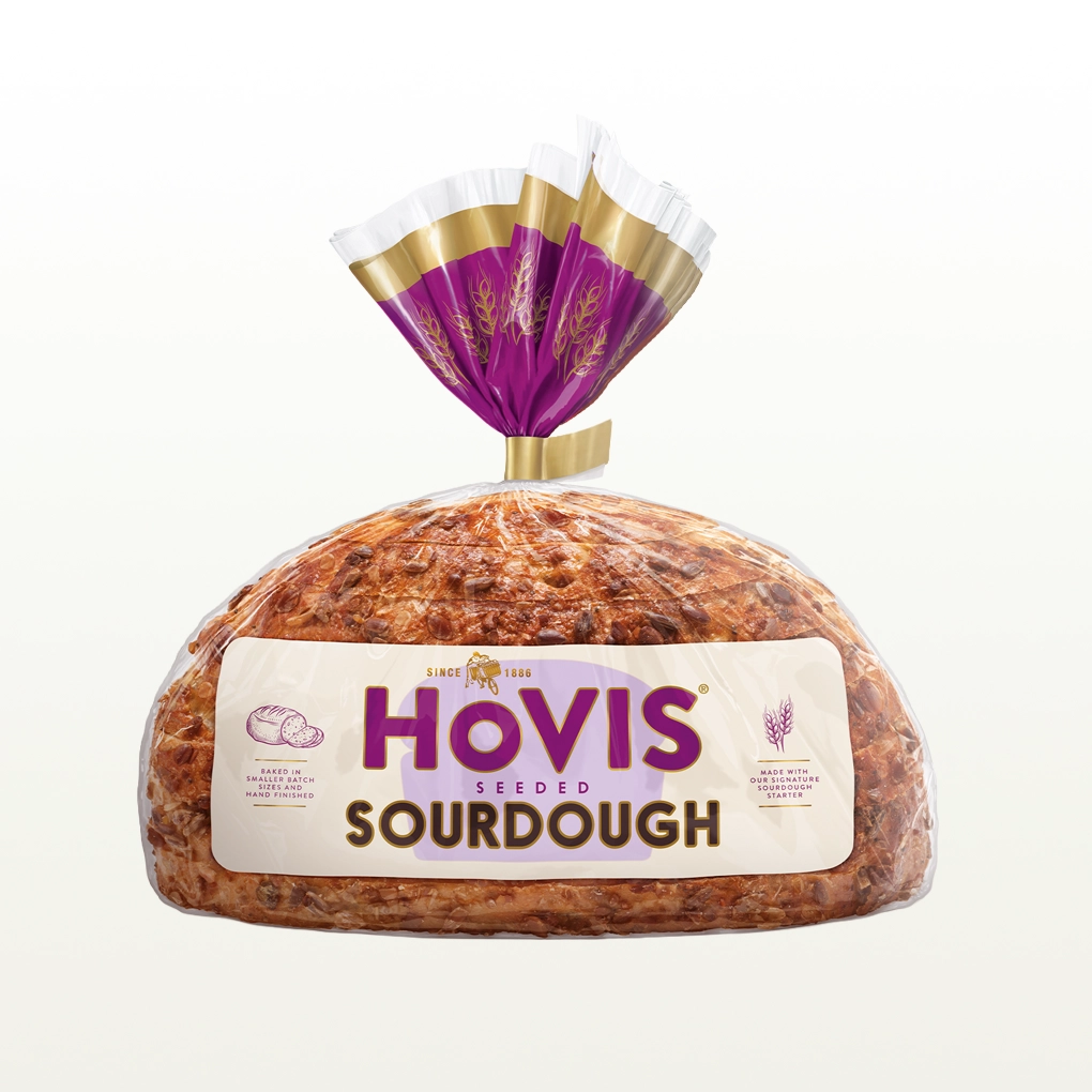 A loaf of hovis seeded sourdough sits in a cream background