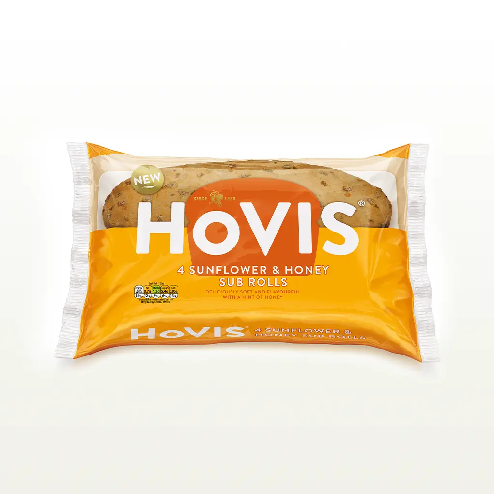 The pack shows two soft sub rolls with delicious sunflower seed on top “Deliciously soft and flavourful with a hint of honey.” The pack sits on a white backdrop with a subtle shadow.