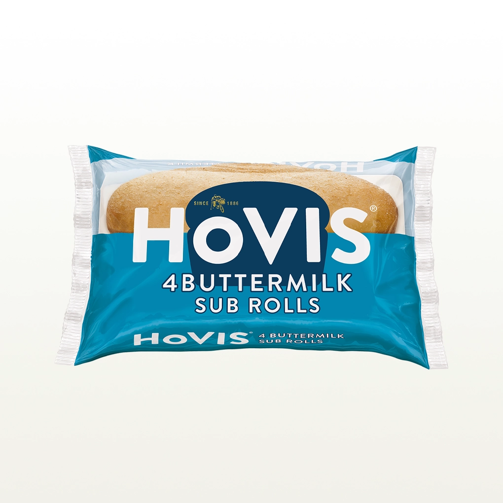 The pack shows two soft sub rolls and highlights “Deliciously soft and flavourful with a hint of buttermilk.” The pack sits on a white backdrop with a subtle shadow.
