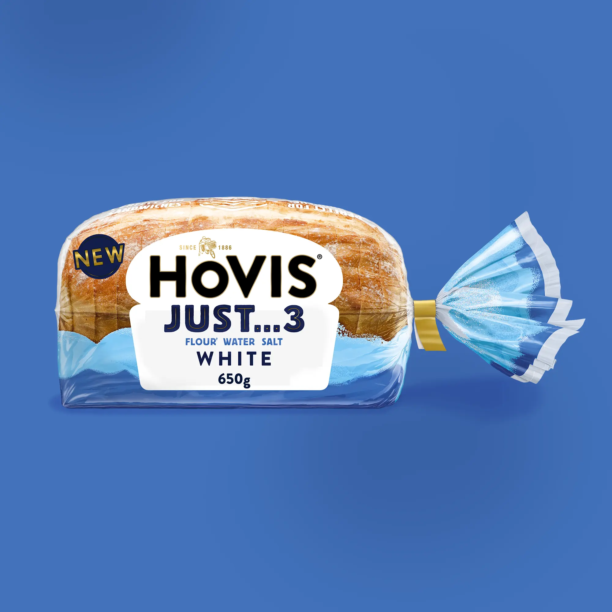 A bagged loaf of Hovis Just 3 white bread in clear and light-blue wrapper with a yellow clip, set against a blue background.